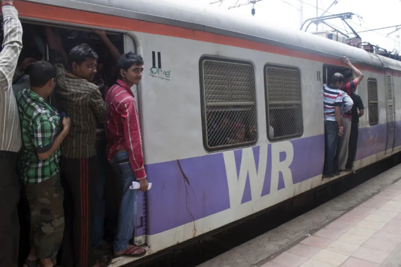 MUMBAI, INDIA - AUGUST 21: Commuting by train on August 21, 2011 in Mumbai, India. Mumbai Suburban Railway carries more than 7 million commuters on a daily basis.