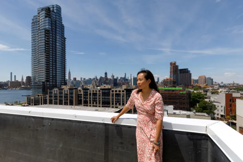 Alyce Chan on the rooftop of her apartment building in the Greenpoint section of Brooklyn on June 12, 2019. Chan bought a two-bedroom unit four years ago, but says her growing family can't afford to stay in the area because all the new development has driven prices up. (Stefano Ukmar/The New York Times)
