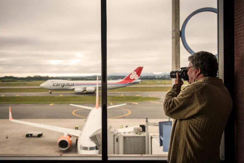 Afonso Delagassa fotografa a chegada de um avião cargueiro ao Afonso Pena. A fotografia do aeroporto e das aeronaves é hobby desde 1985. Foto: Leticia Akemi/Gazeta do Povo