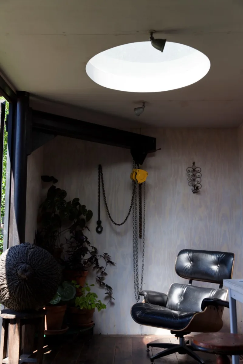 A second-story room, which includes a jib crane for hauling items up from the ground, in artist Lars Fisk's home that is made of four shipping containers stacked on a weedy lot he rents in the Red Hook neighborhood of New York, Aug. 17, 2016. The thrifty sculptor of public art, best known for his penchant to playfully render familiar objects as spheres, says he has learned to be economical. (Matthew Johnson/The New York Times)